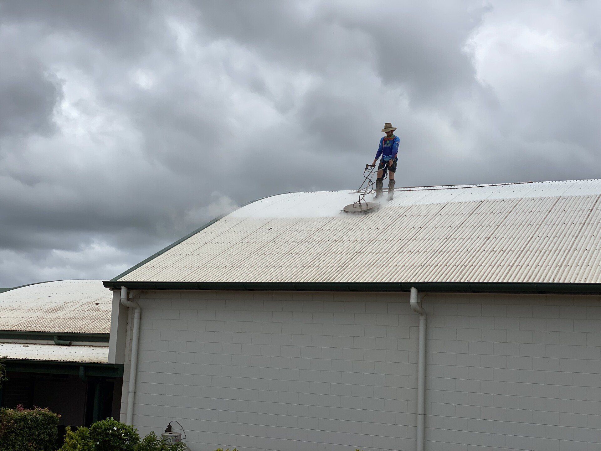 Man Cleaning The Roof — FNQ Pressure Cleaning  in Atherton, QLD