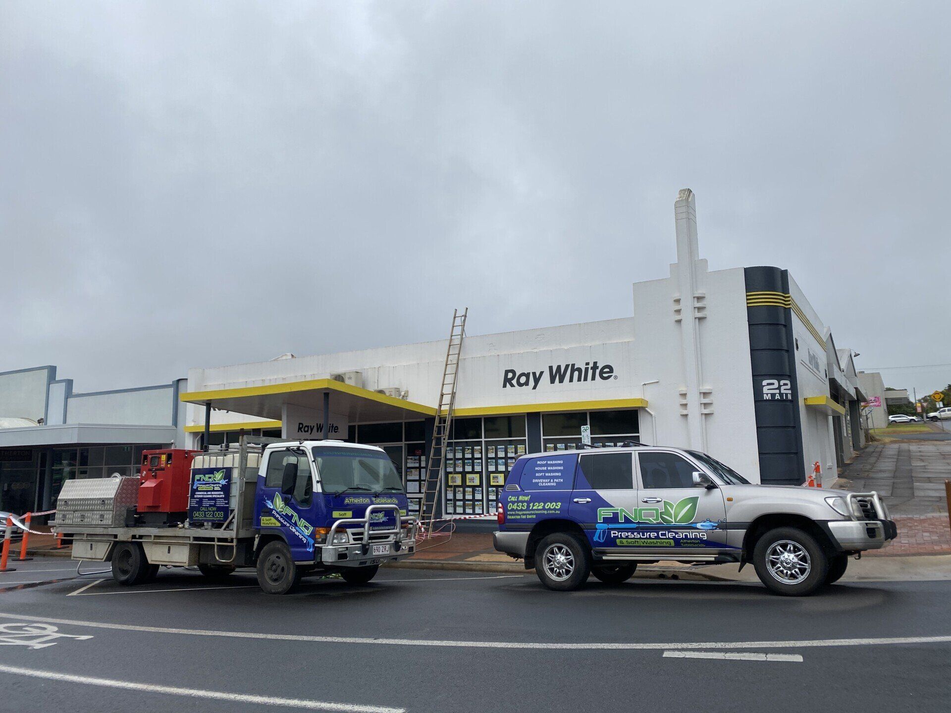 Two Vehicles In Front Of The Ray White Building — FNQ Pressure Cleaning  in Atherton, QLD