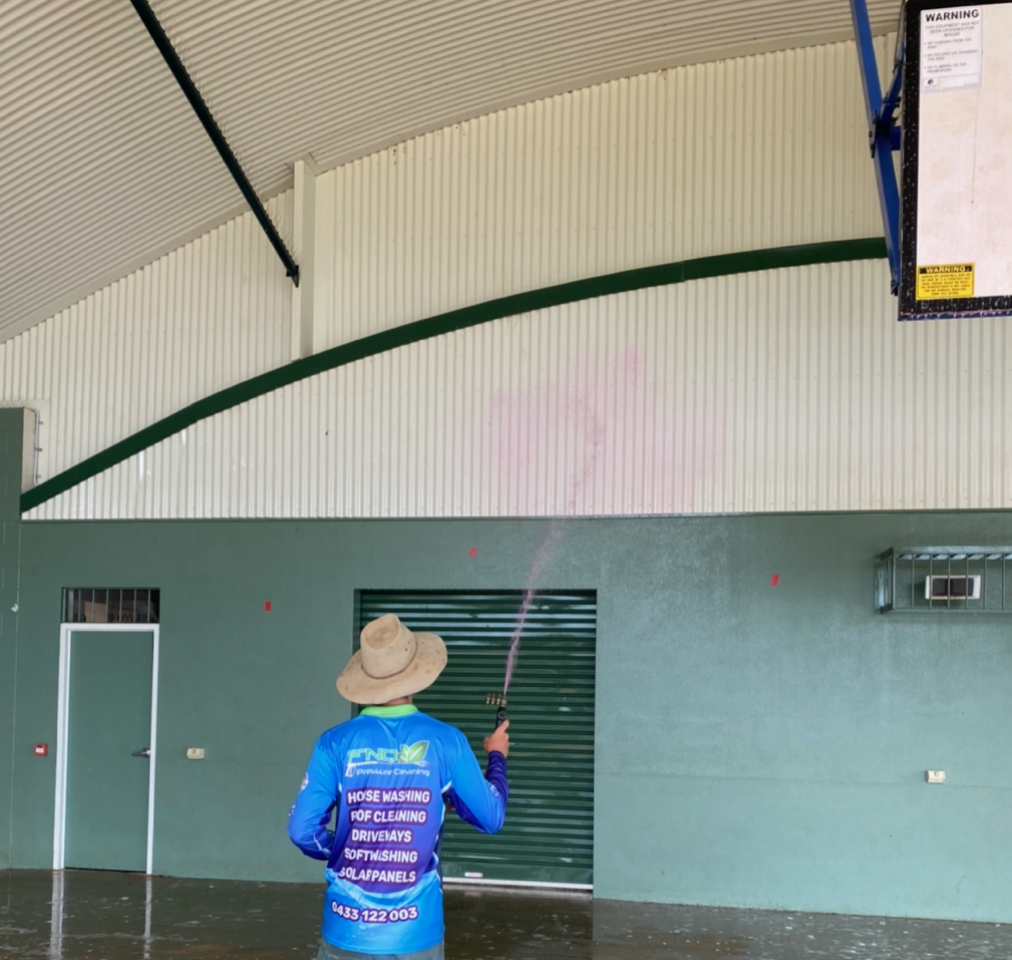 Man Cleaning The Wall Using Pressure Washer — FNQ Pressure Cleaning  in Atherton, QLD