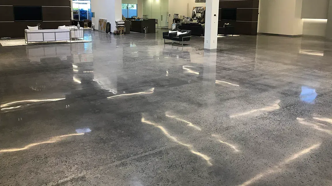 A large room with a shiny concrete floor in a building.