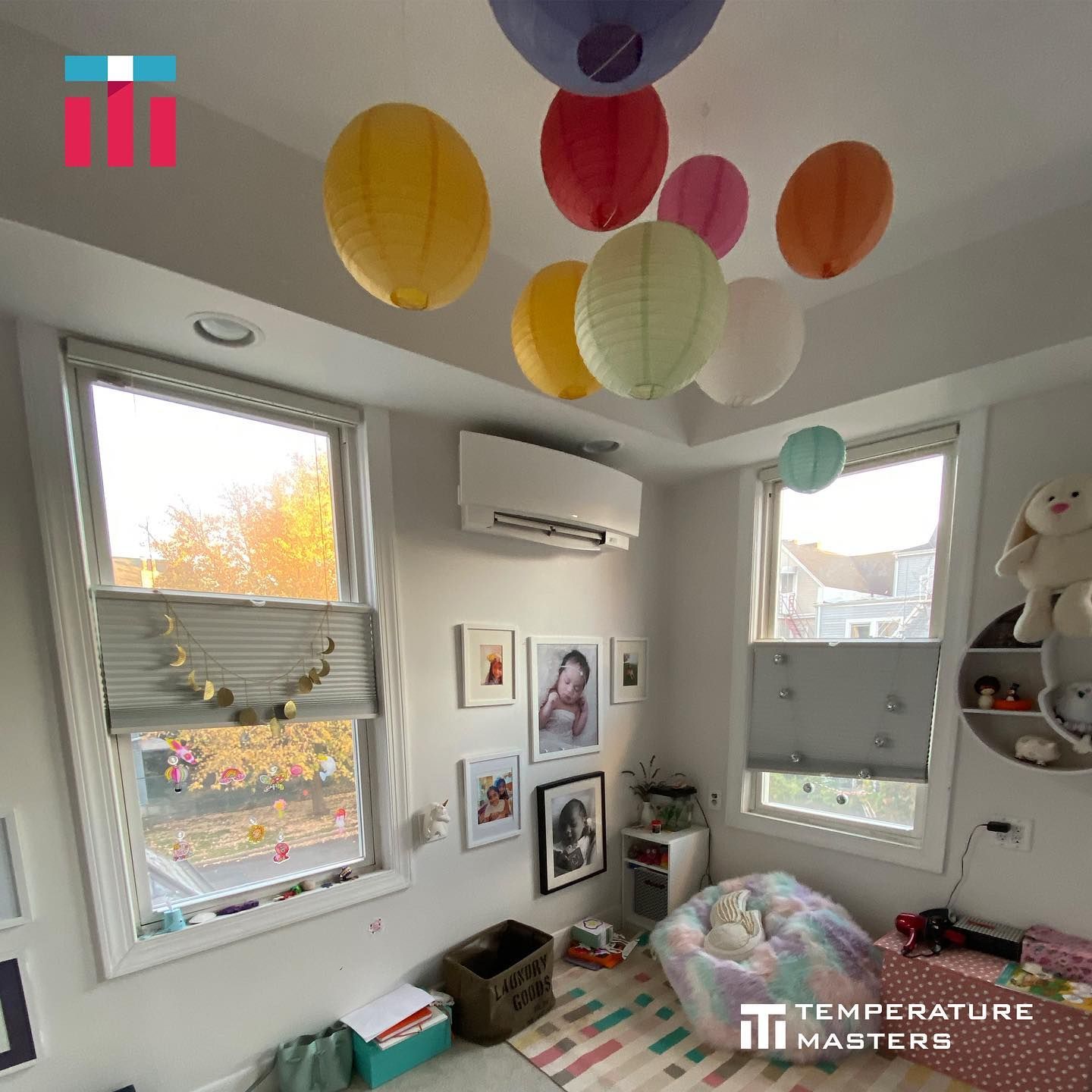 A room with balloons hanging from the ceiling and the words temperature masters on the bottom