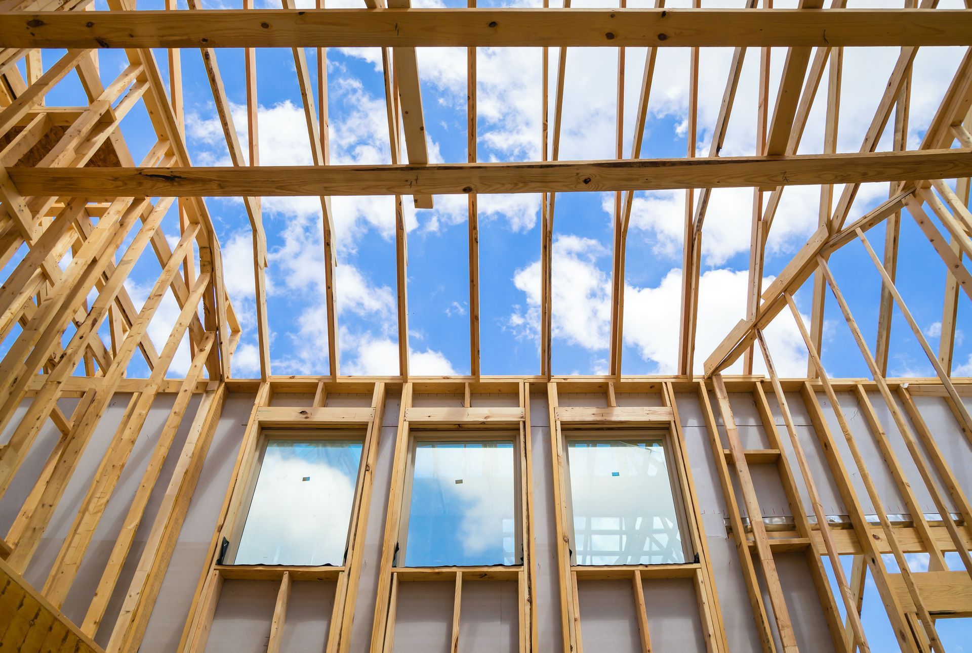 A house is being built with a blue sky in the background.