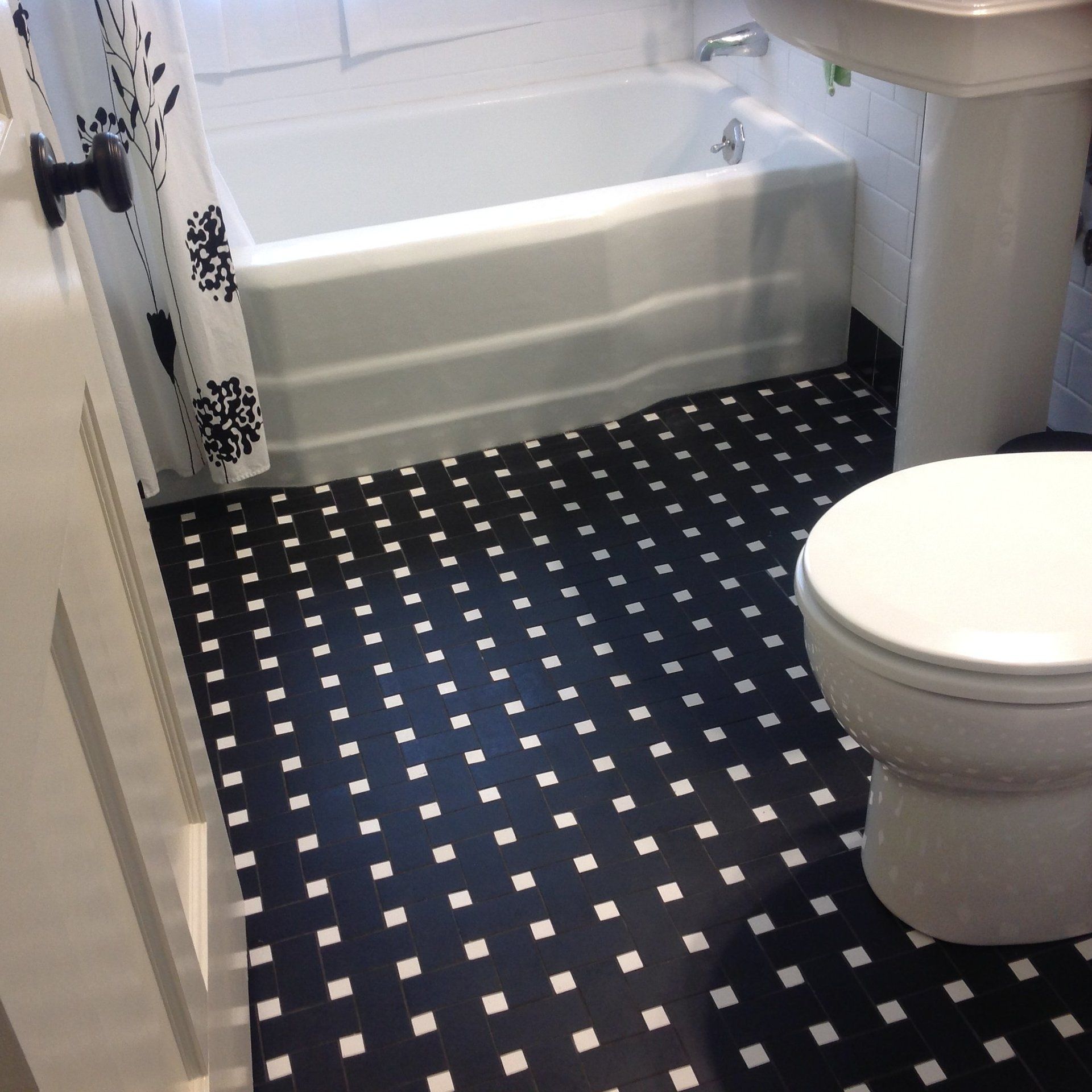 Black with white dot basket weave to a true black and white bathroom