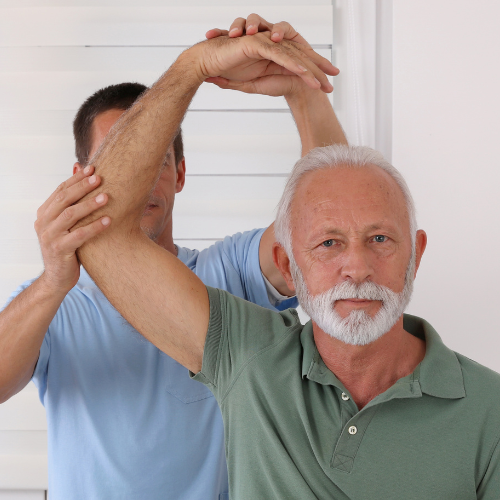Two men stretching arms overhead in a bright indoor room