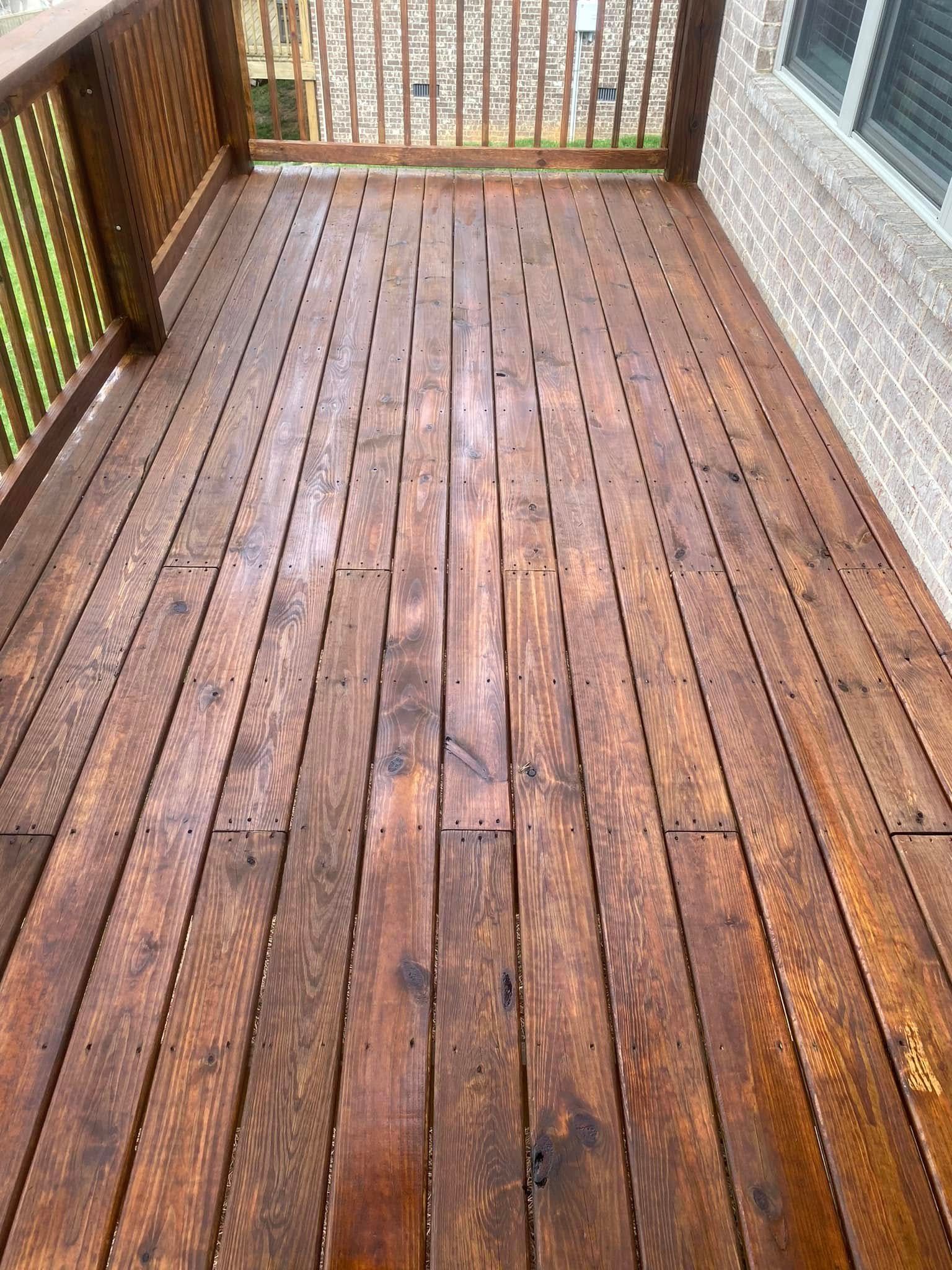 A wooden deck is sitting on top of a brick building.