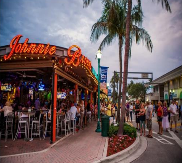 A group of people is gathered outside John's restaurant