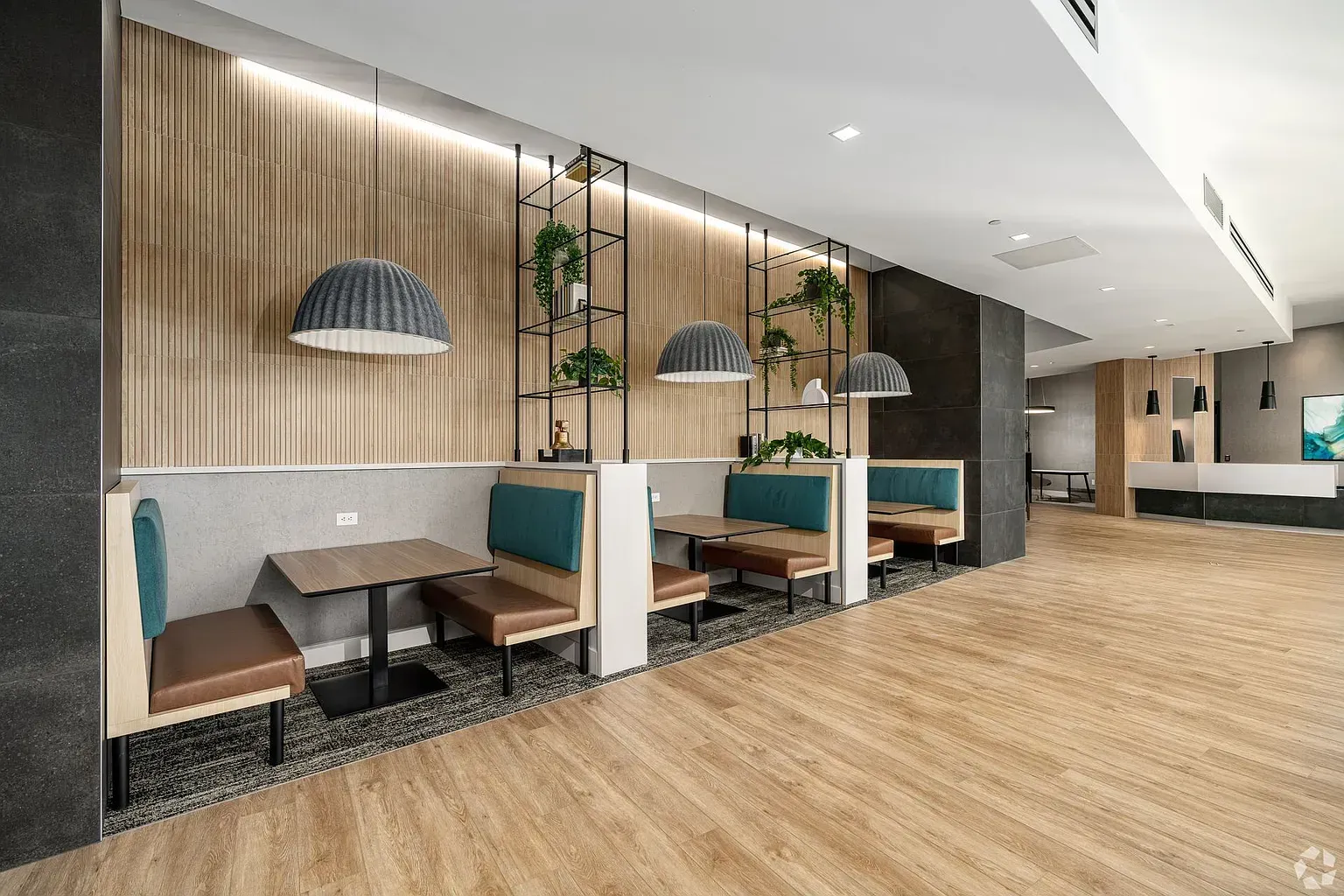 Photo of a community lounge area showing a few booths