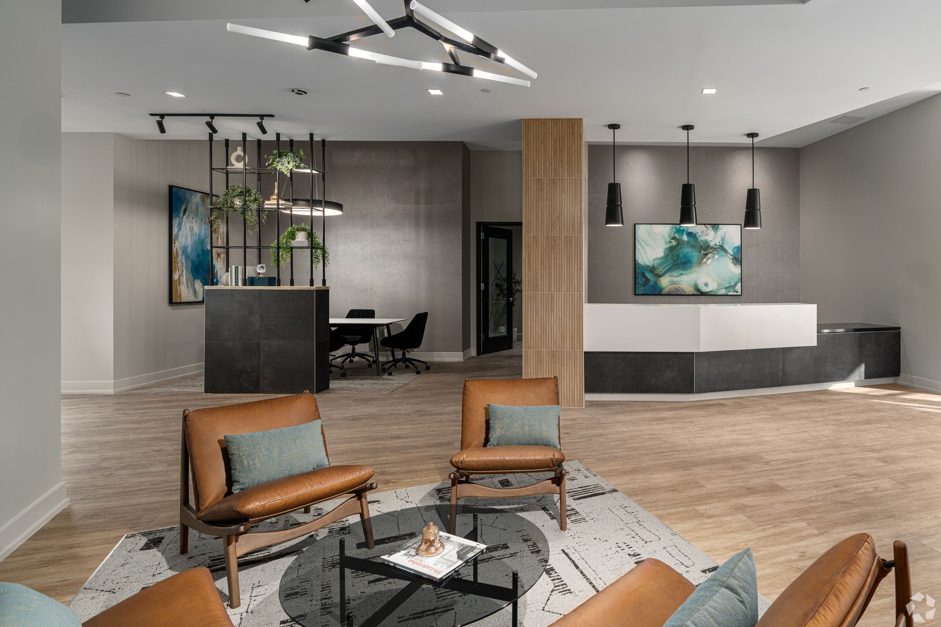 Photo of a community lounge with a couple of seating areas visible