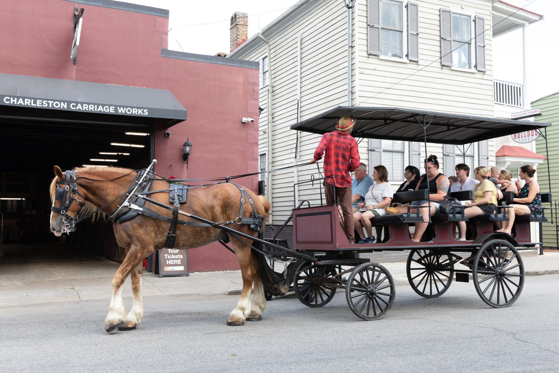 A horse drawn carriage with people sitting in it