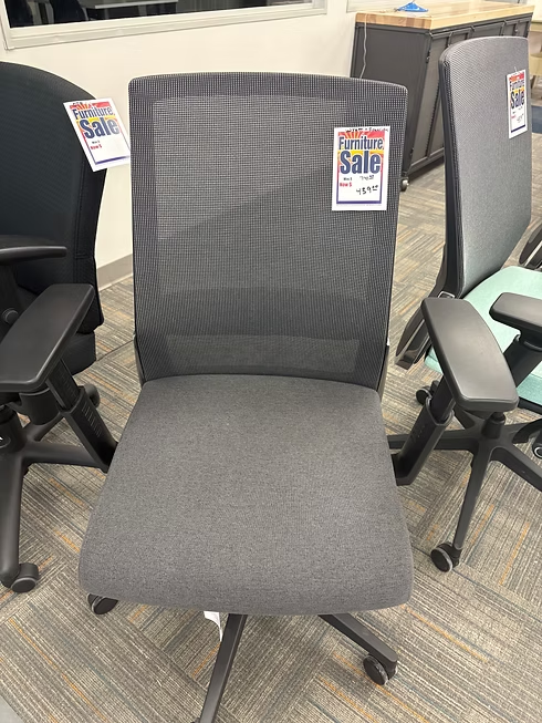 Gray mesh-backed office chair with padded seat, black armrests, and a 