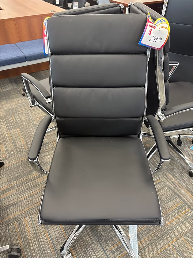 Black office chair with a ribbed back and chrome arms and base.