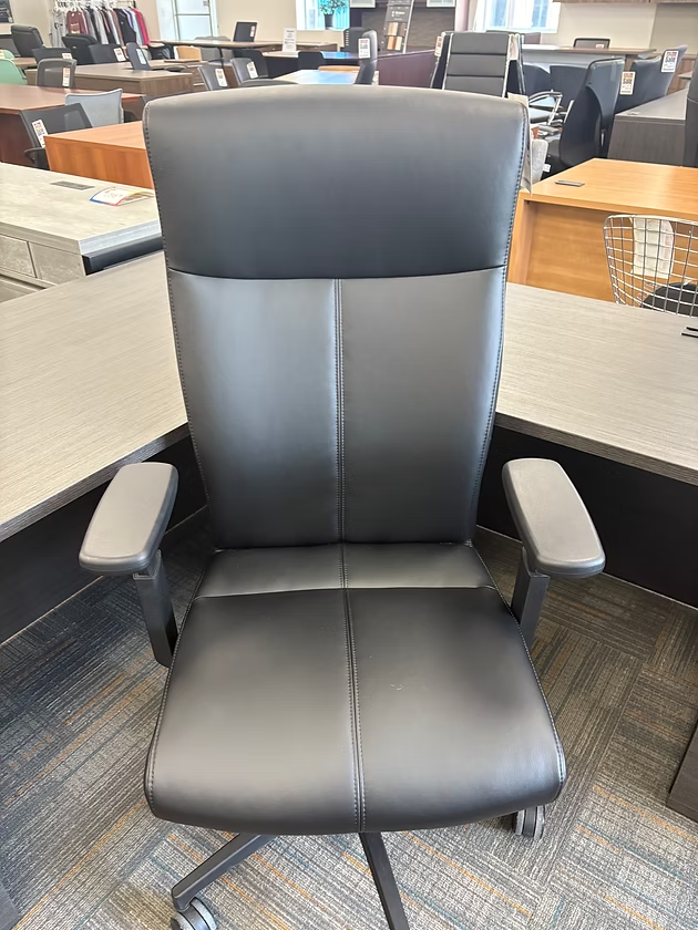 Black office chair with high back, gray arms, and rolling base.