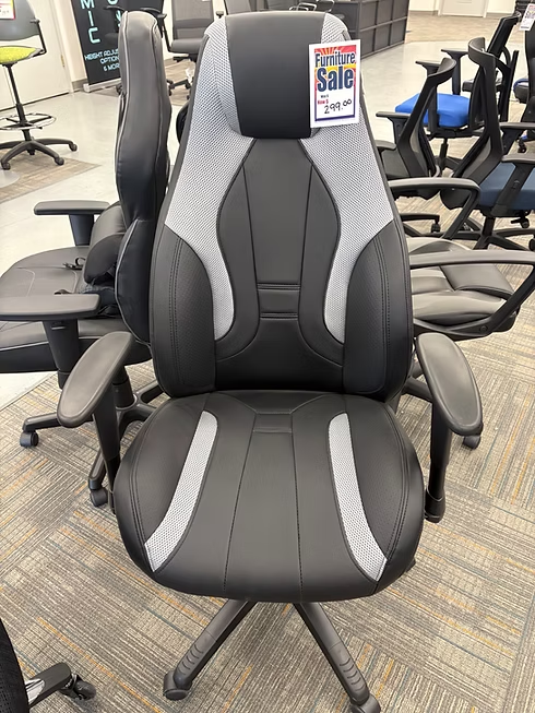 Black and gray office chair on sale in a store, with gray accents and armrests.