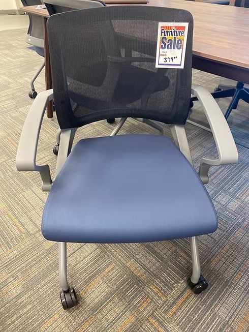 Blue and black mesh office chair on wheels with a sale tag.