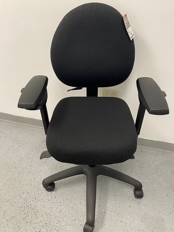 Black office chair with adjustable arms, on wheels.