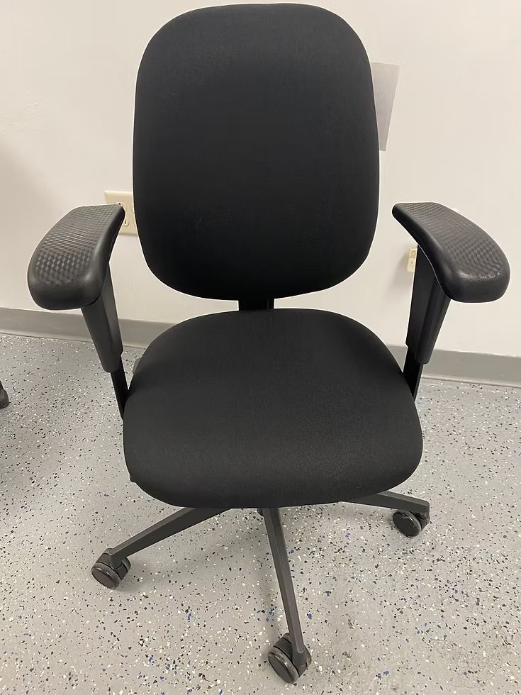 Black office chair on wheels with padded back and armrests.