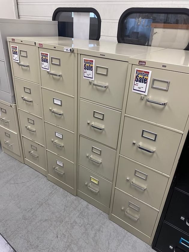 Beige metal file cabinets of various heights, some with