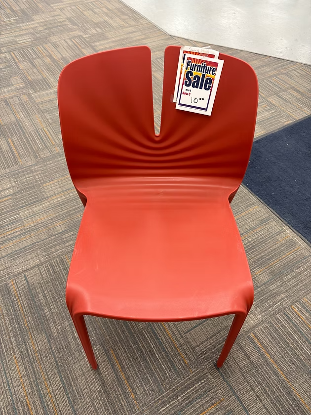 Red plastic chair with back slit,