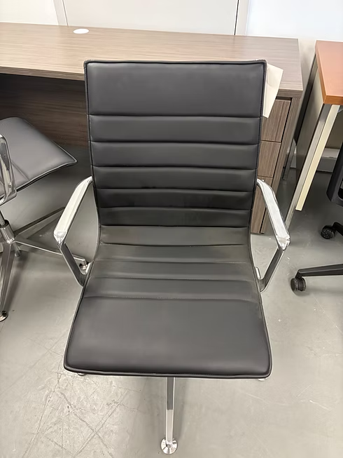 Black leather office chair with chrome arms and base.