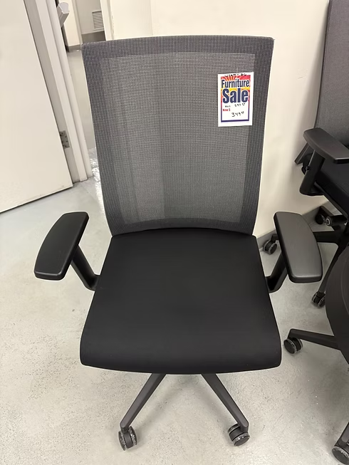 Black mesh office chair on sale, gray wheels, dark padded seat and arms.