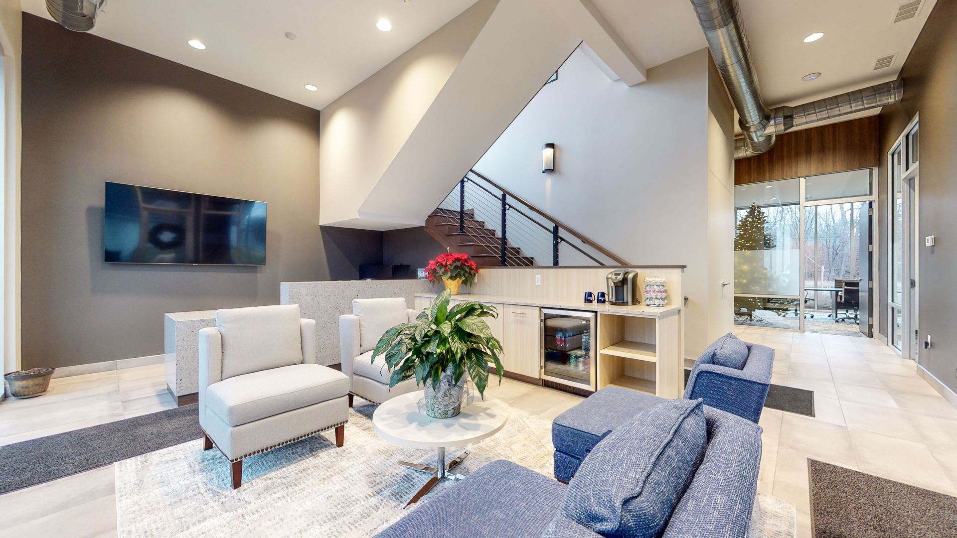 A living room filled with furniture and a staircase.