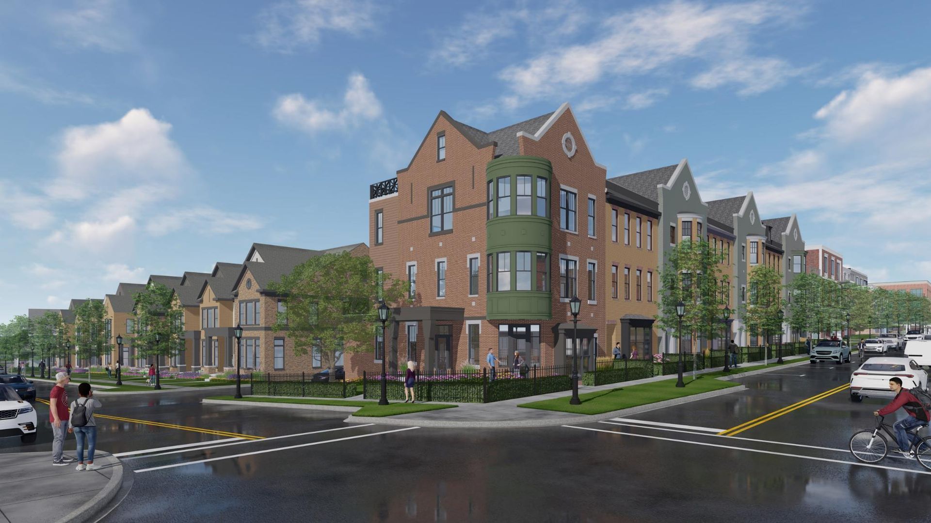 Row of townhomes at a street corner; red brick facade with green accents.