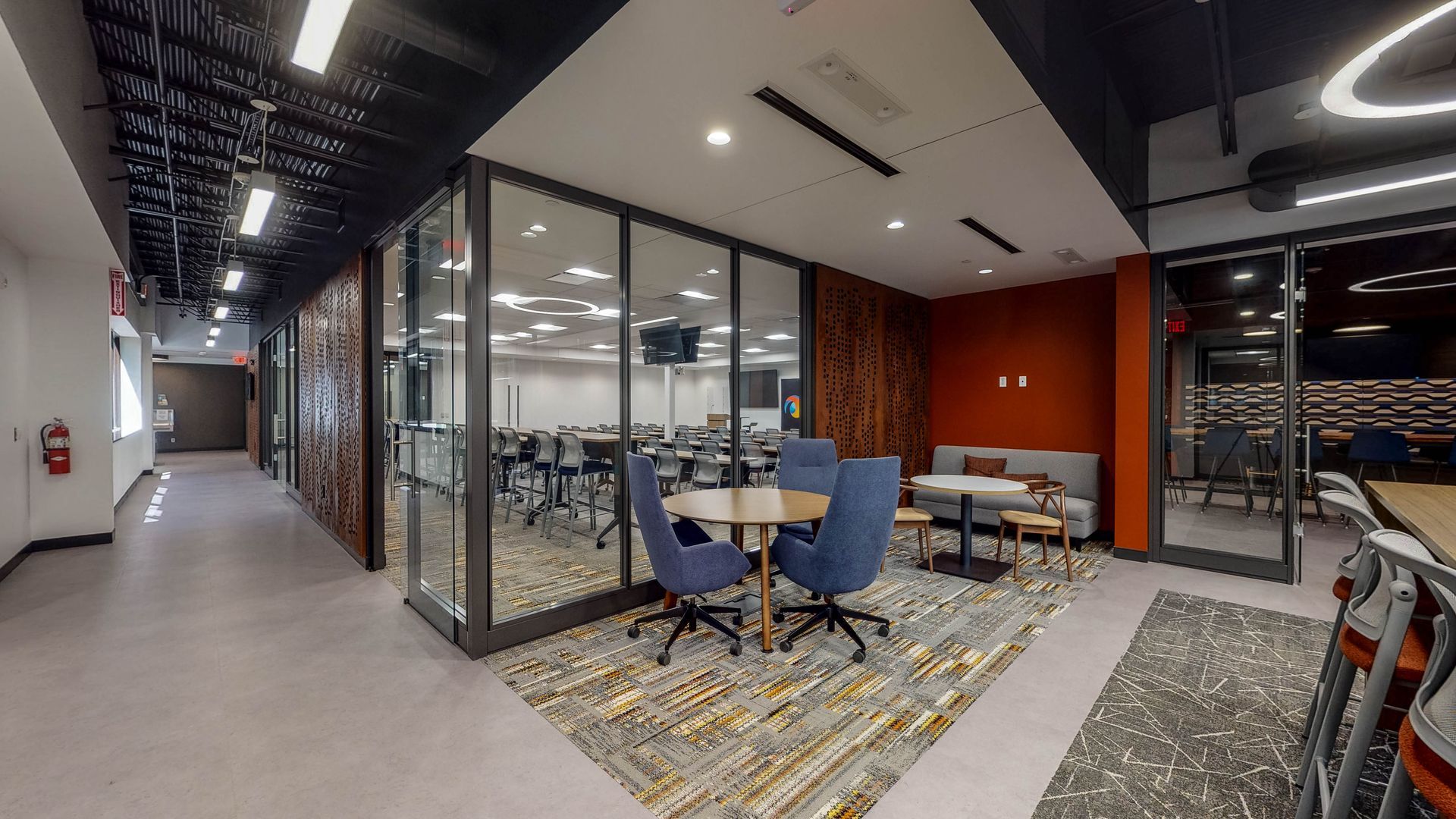 A large room with tables and chairs in it.