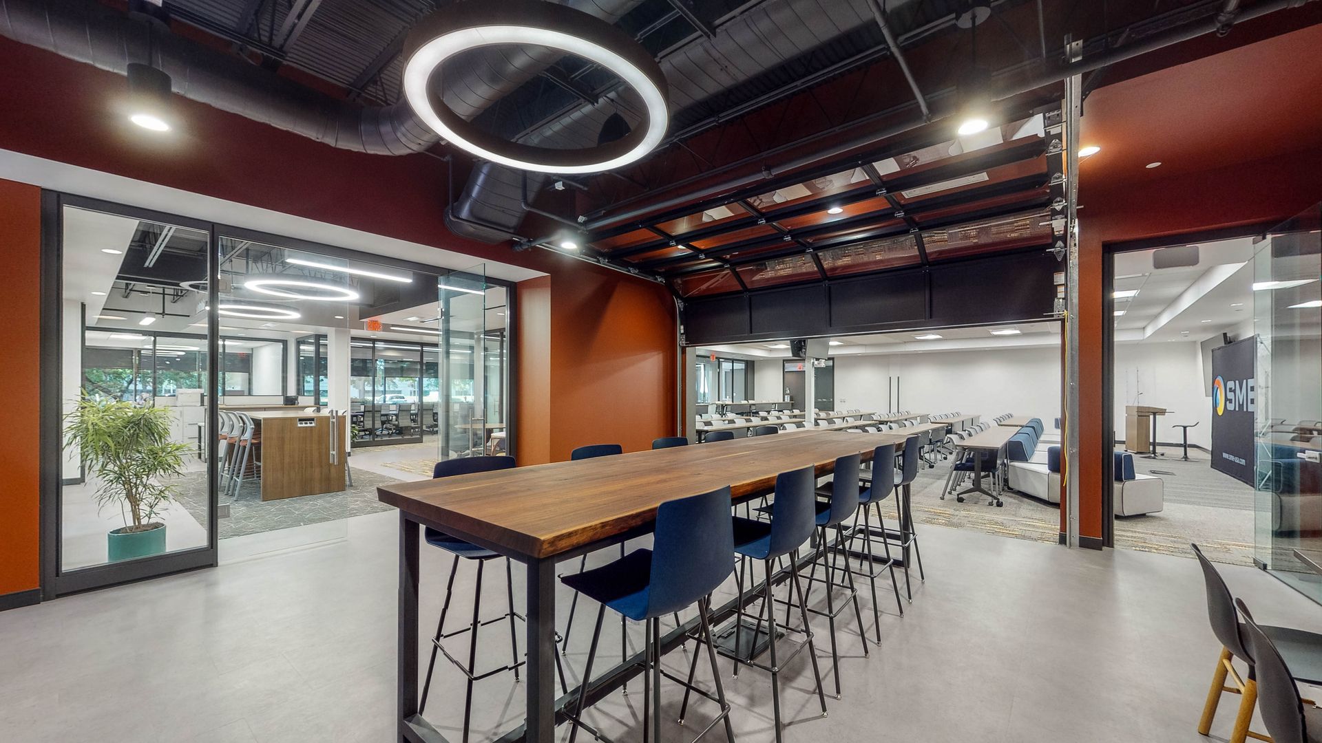 A large room with a long table and chairs in it.