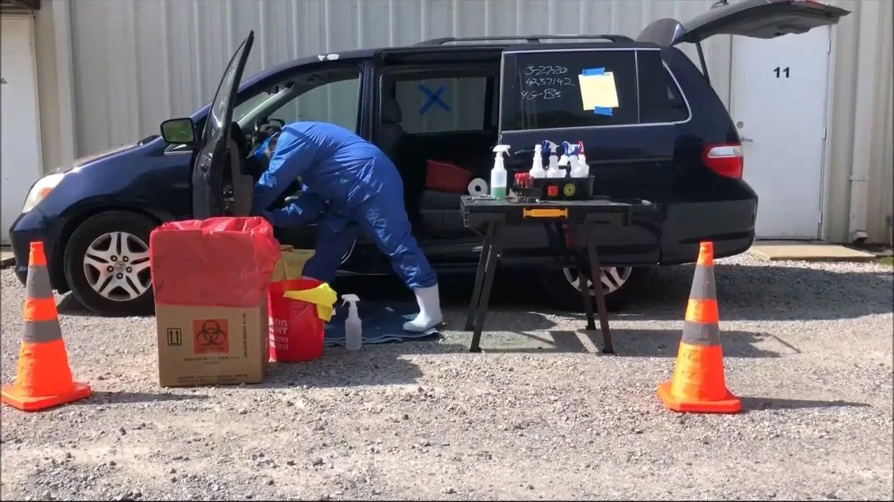 Professional Biohazard Worker Cleaning a Vehicle