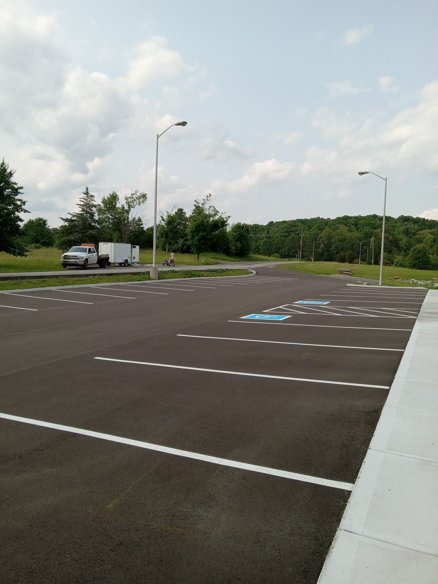 A parking lot with a blue arrow pointing to a handicapped parking spot