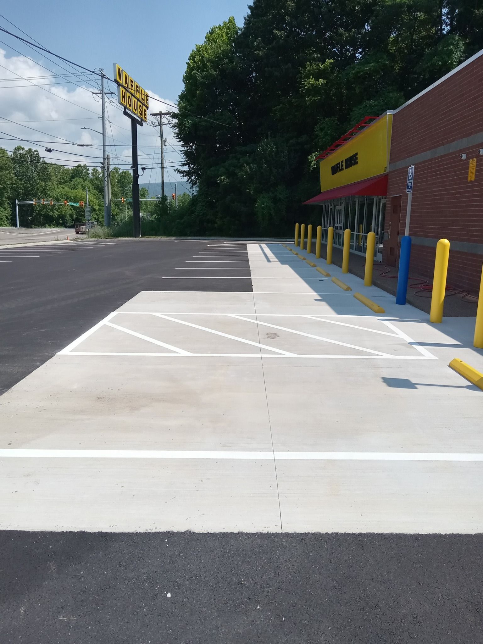 A parking lot with a yellow building in the background