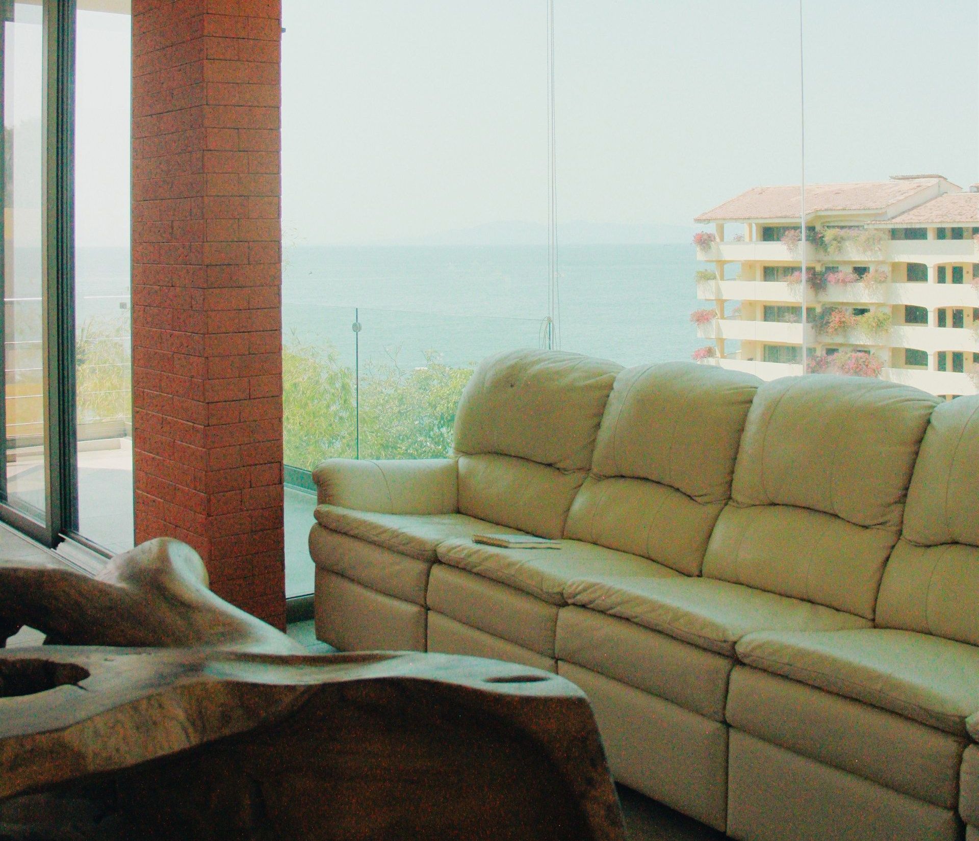 Una sala de estar con un sofá y una mesa con vista al mar.