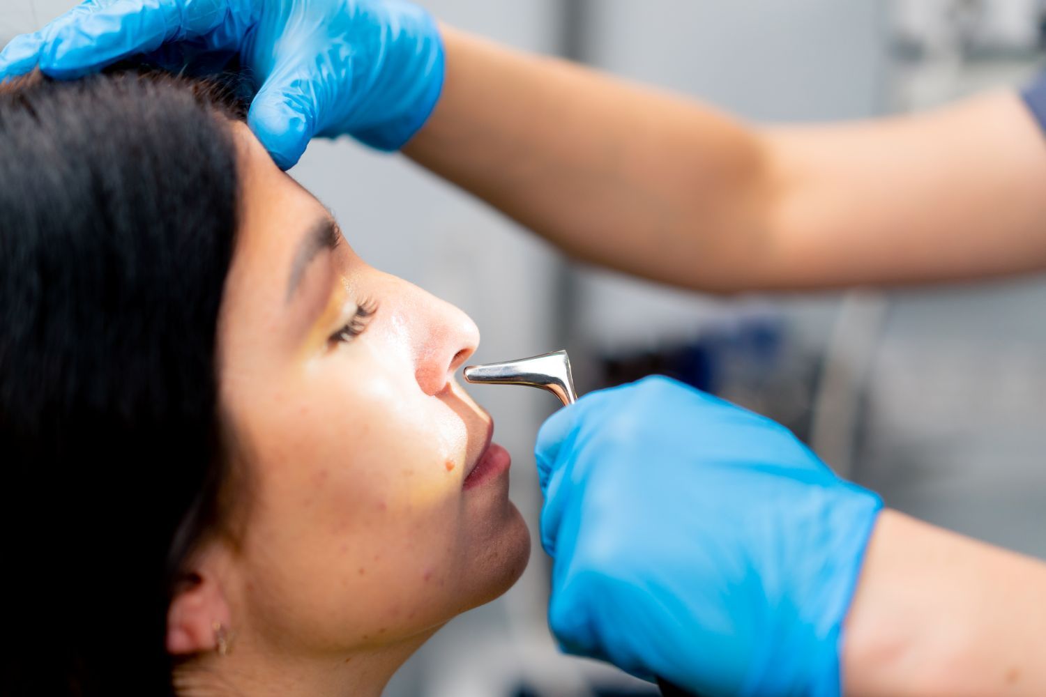 close-up-photo-of-a-sinus-doctor-examining-nasal-cavity-of-the-patient