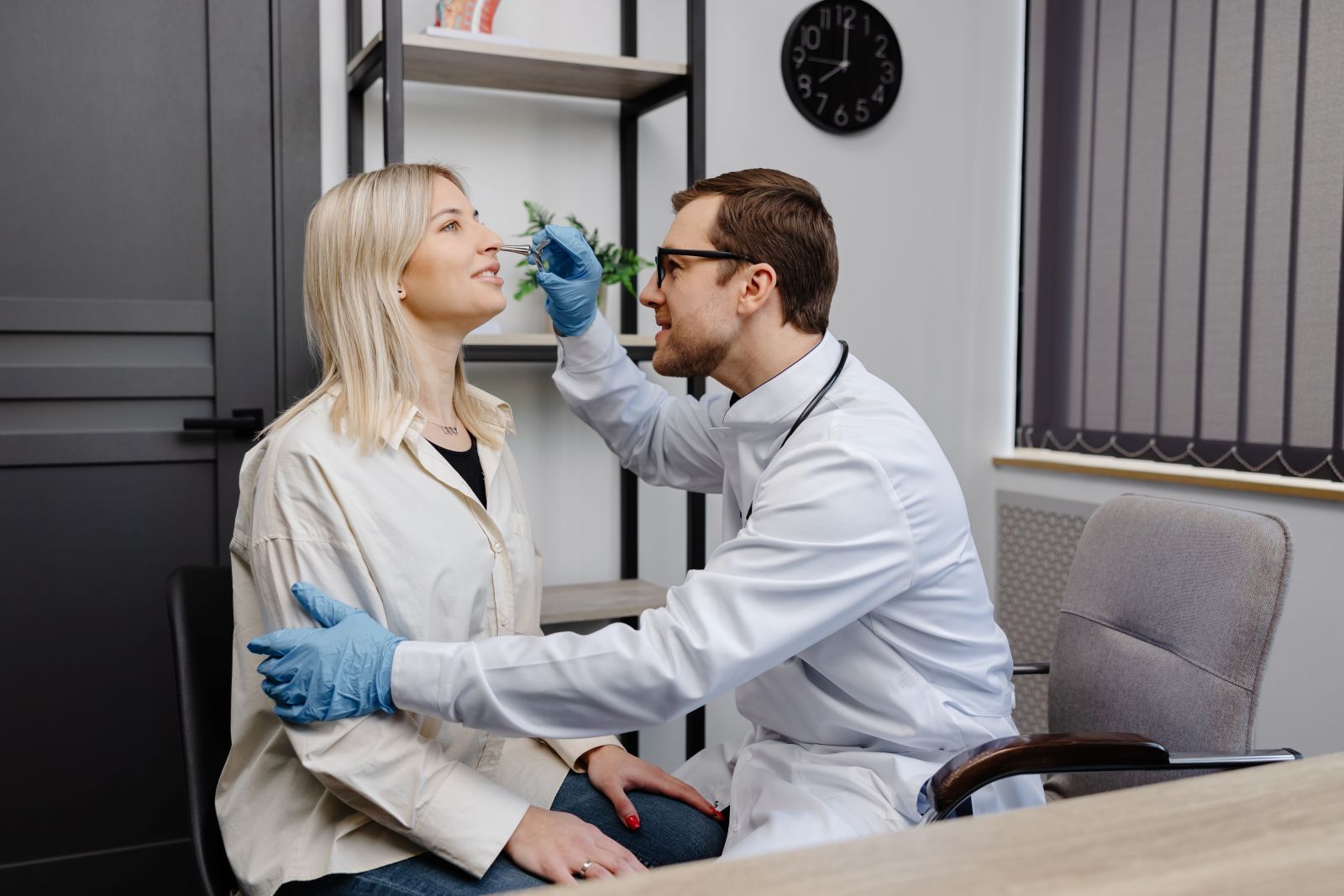Nose doctor checking on patient