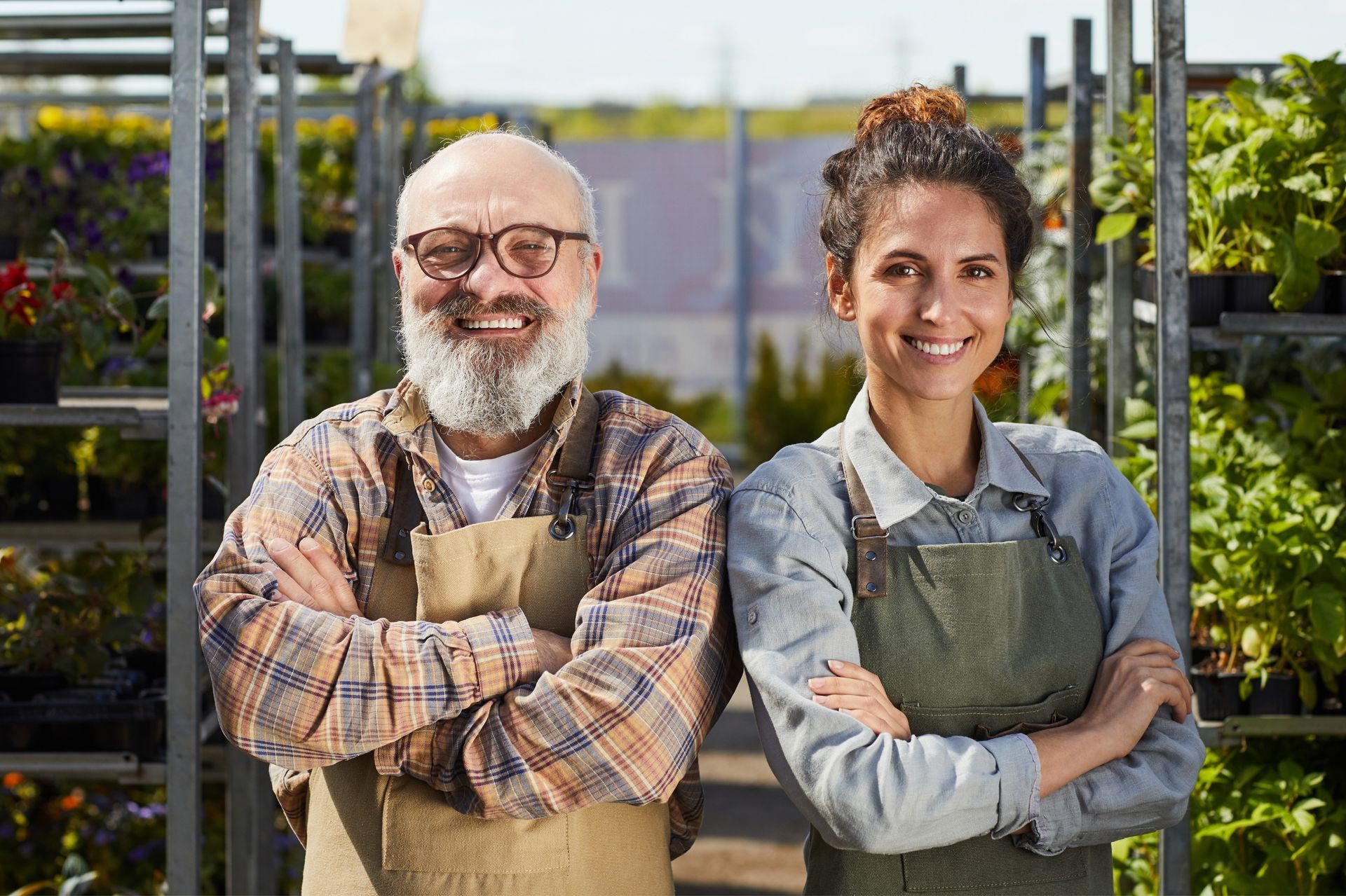 A man and a woman are posing for a picture in a garden center.