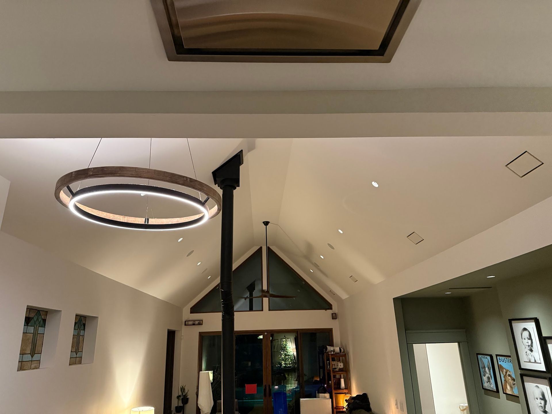 Vaulted ceiling interior with skylight and circular light fixture.
