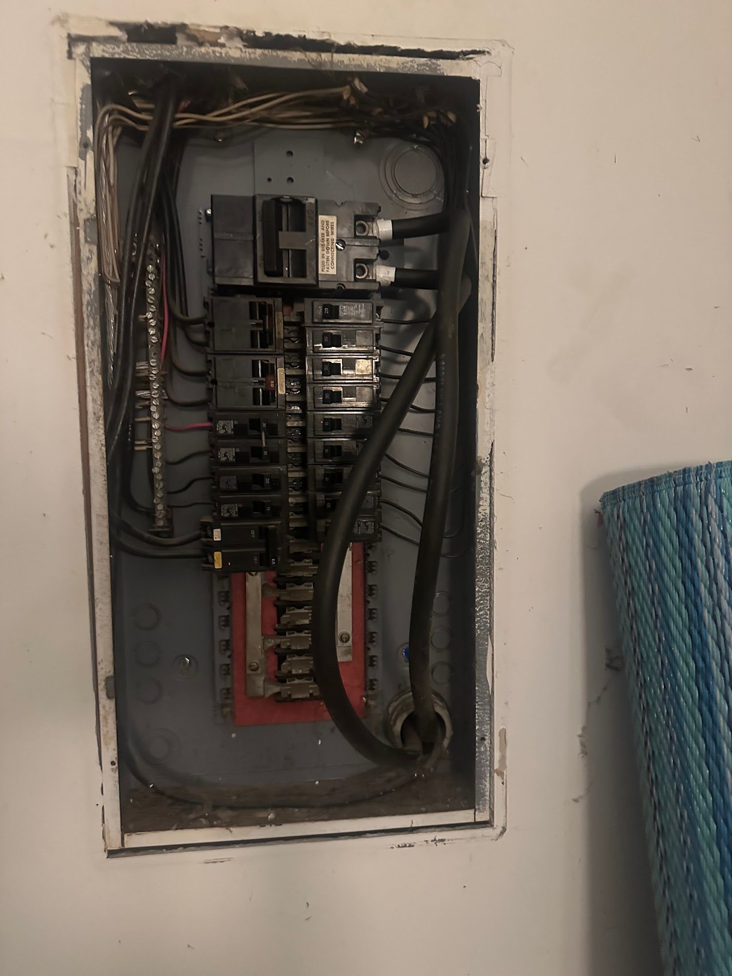 Electrical panel installed in a wall. Contains breakers and wiring.