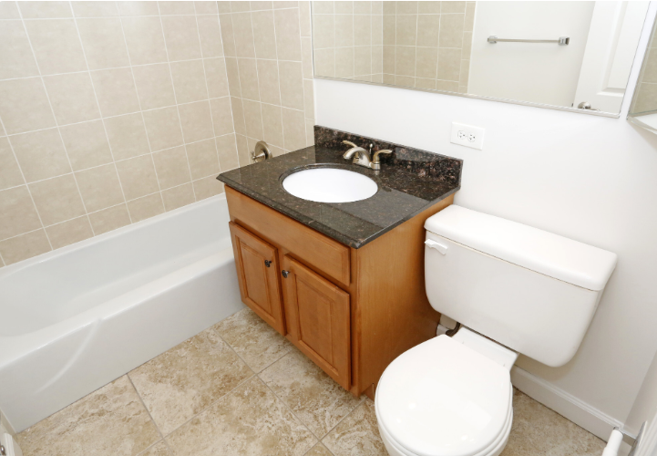 Photo of a bathroom with dark countertop