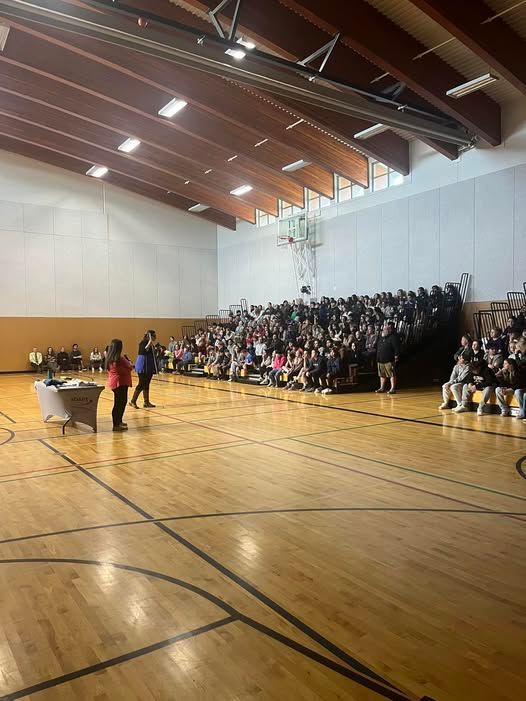 The Youth aDAPT team is presenting to the whole school in the gym.