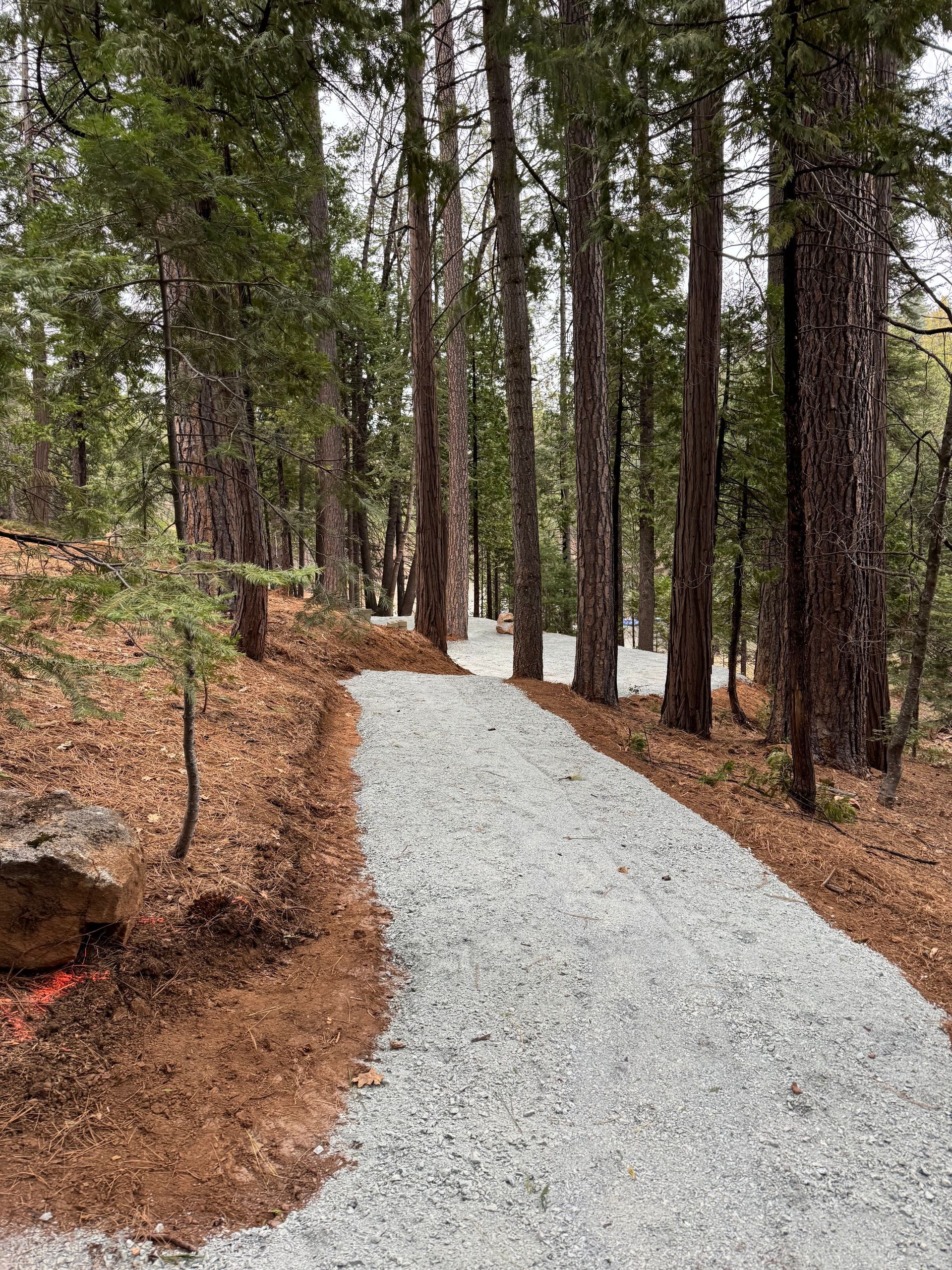 A man is digging a hole in the ground to install a pipe.