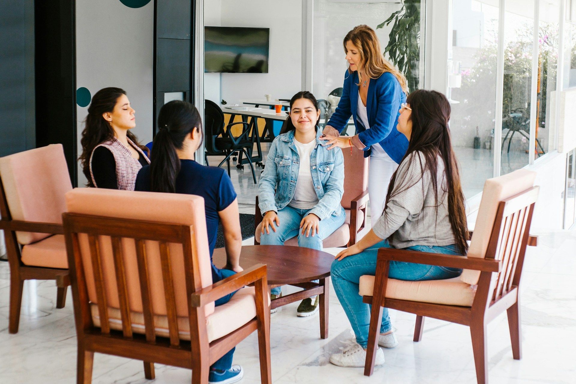 Man and woman looking at paperwork in a warehouse setting, surrounded by boxes on shelves.