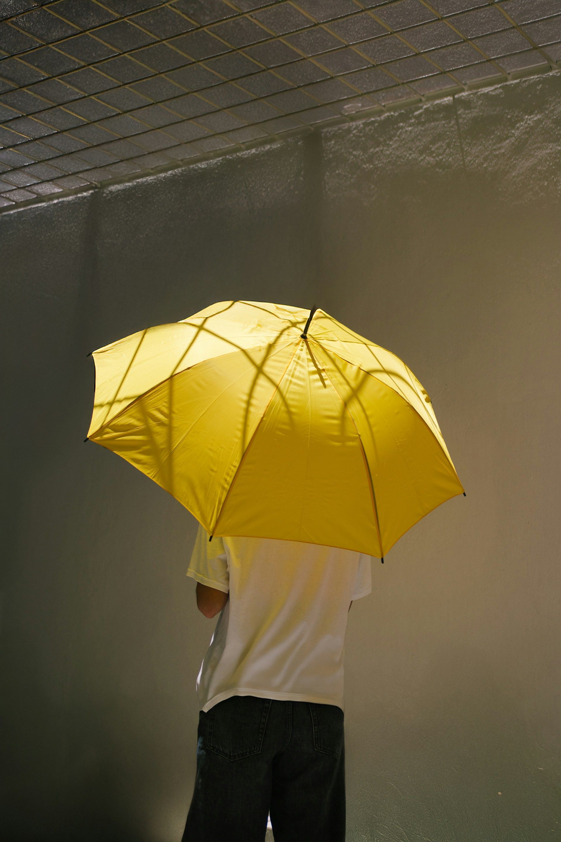 An aerial view of a man pushing a pallet truck in a warehouse.
