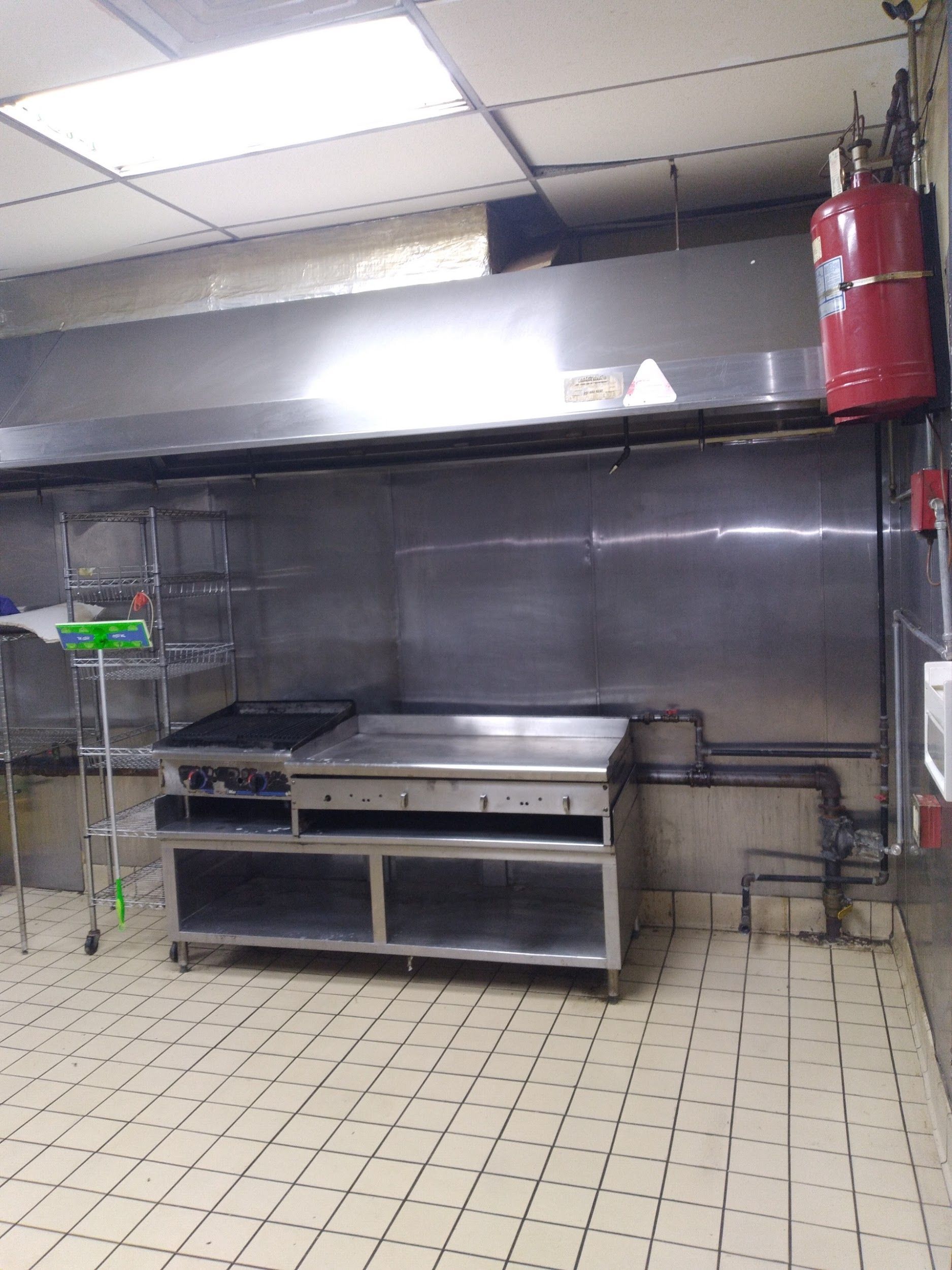 A kitchen with stainless steel appliances and a fire extinguisher