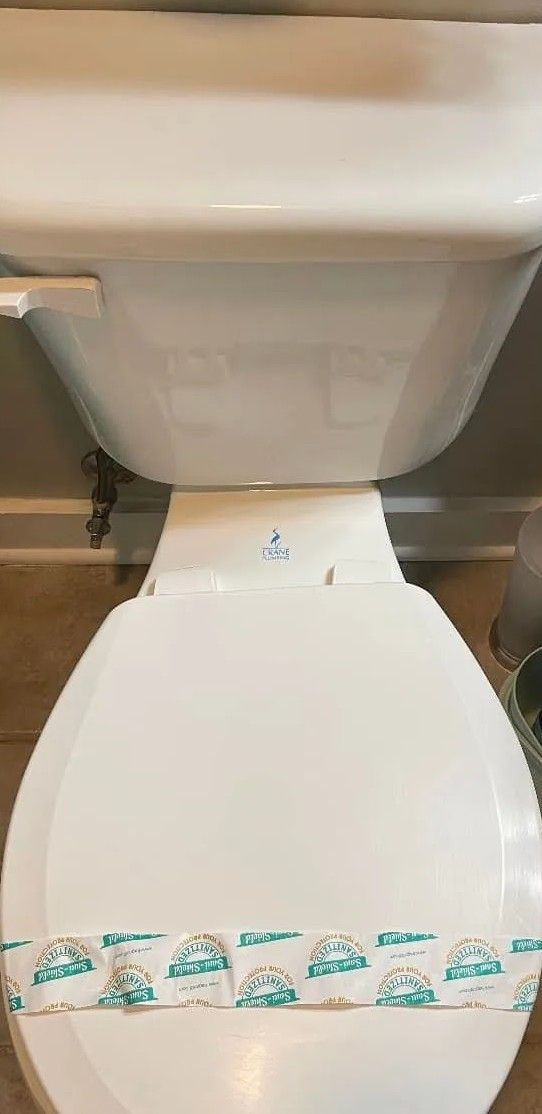 A close up of a toilet in a bathroom.