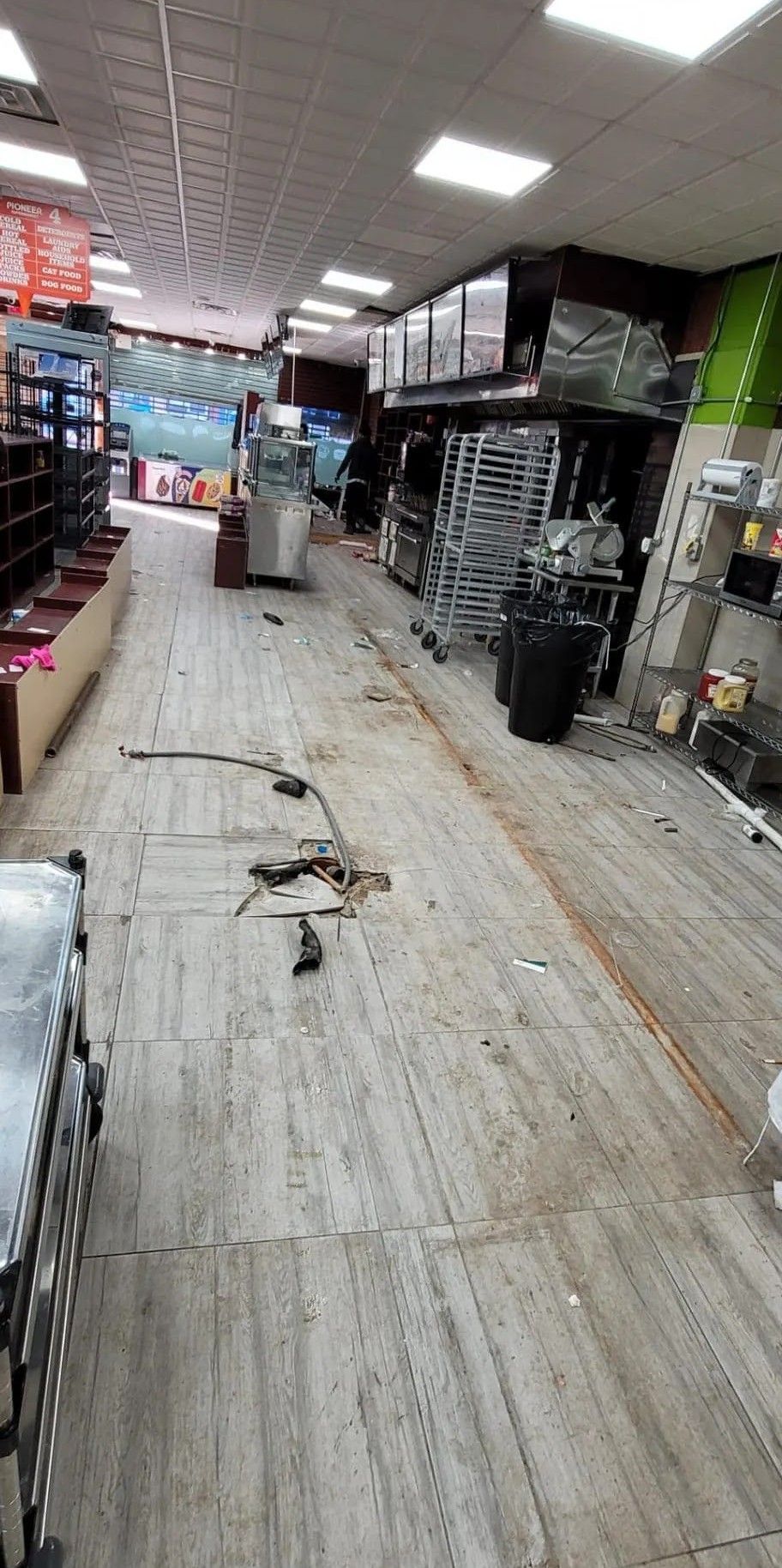 A snake is laying on the floor of a store.