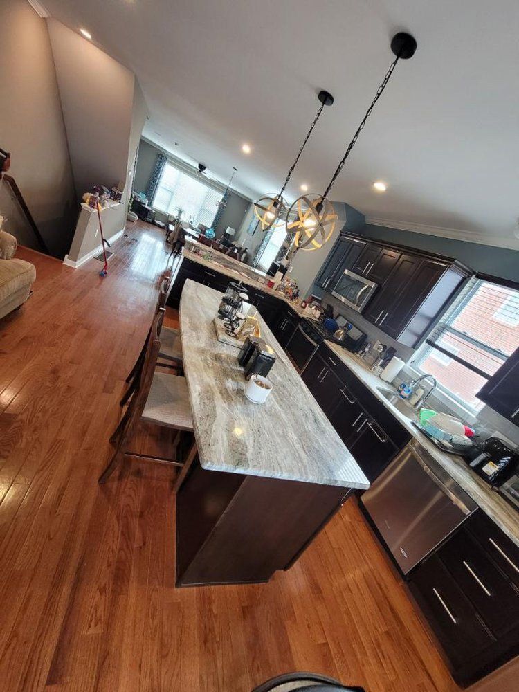 A kitchen with a large island and stainless steel appliances.