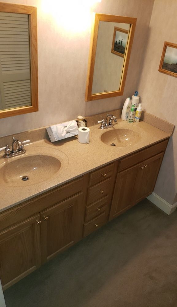 A bathroom with two sinks and two mirrors.