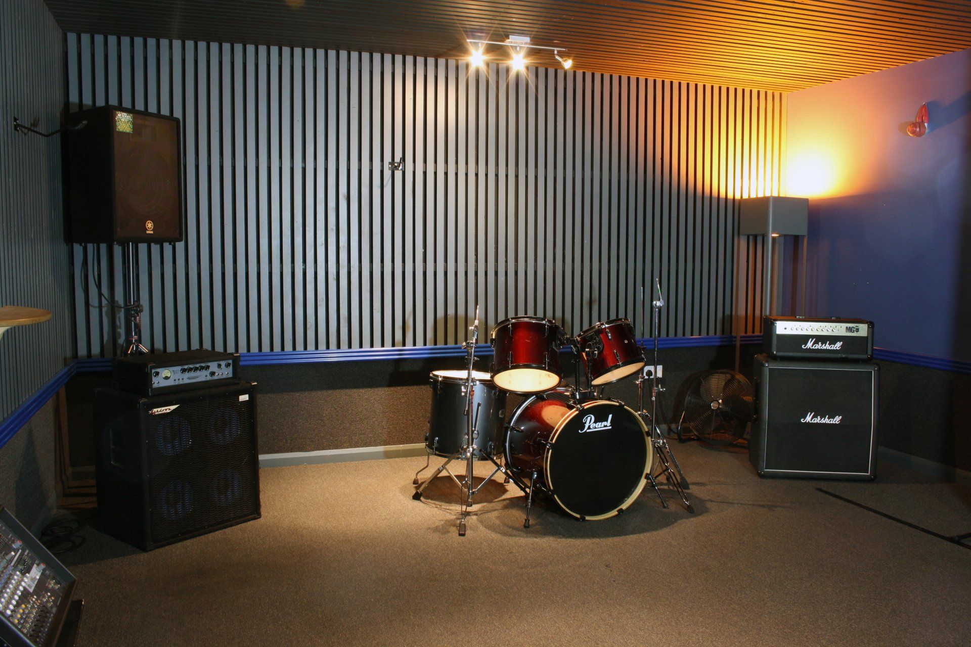 A drum set in a room with a pearl drum