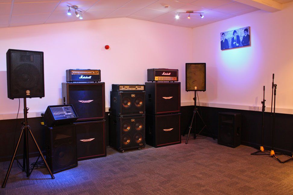 A room filled with lots of speakers and a microphone.