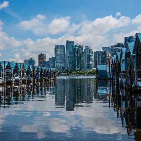 A calm body of water with city in the background